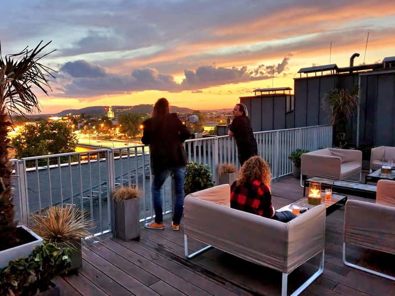 Krakow: Hidden Rooftop Bar Reservation with 1 Cocktail - What the 6th-floor terrace feels like at night